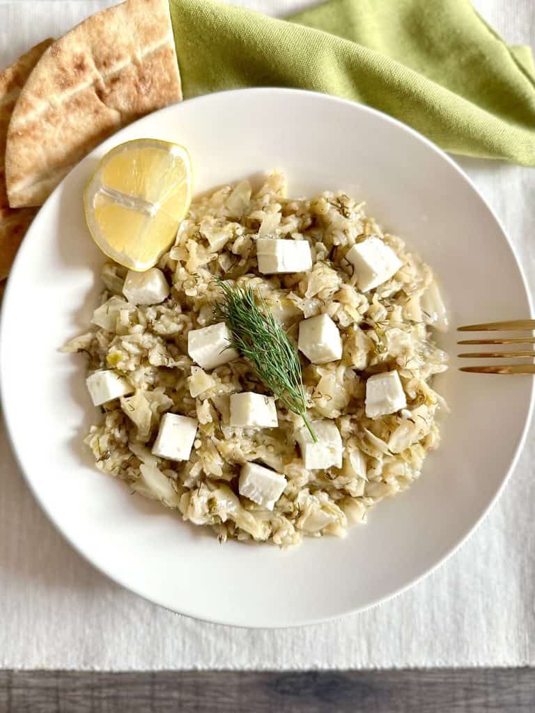 Instant Pot Greek Cabbage Rice Lahanorizo on a dish with lemon and feta and pita