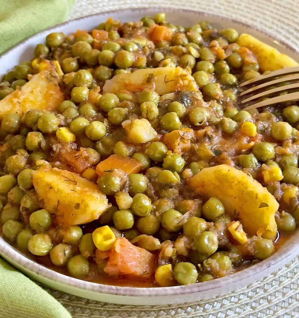 Instant Pot Greek Peas in Red Sauce on a plate with potatoes