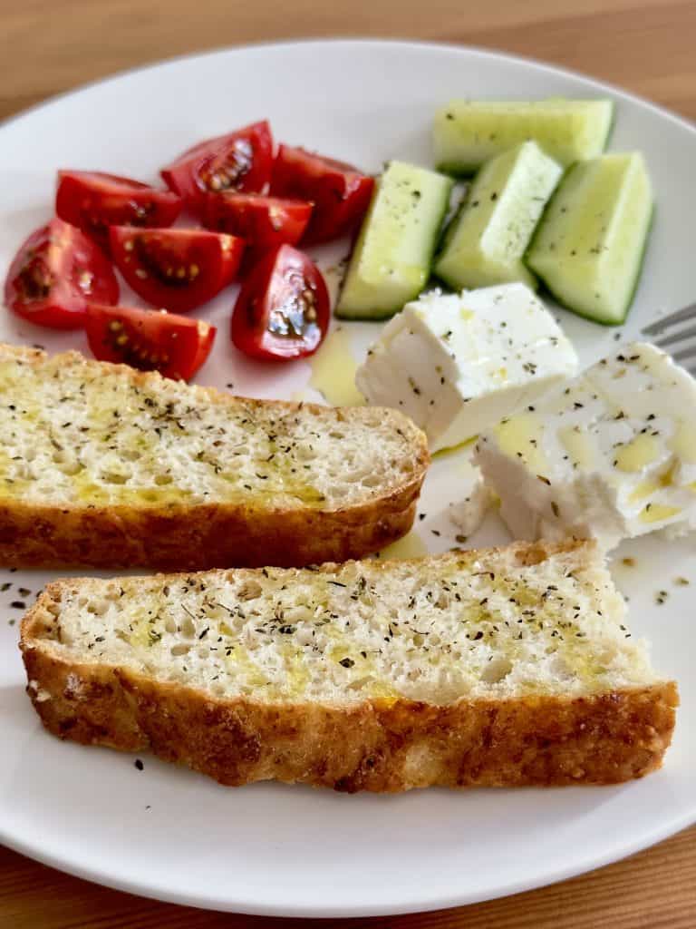 Homemade oat bread with tomatoes, cucumbers, and feta cheese