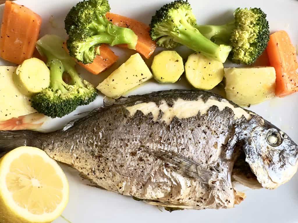 Roasted fish with vegetables on a dish