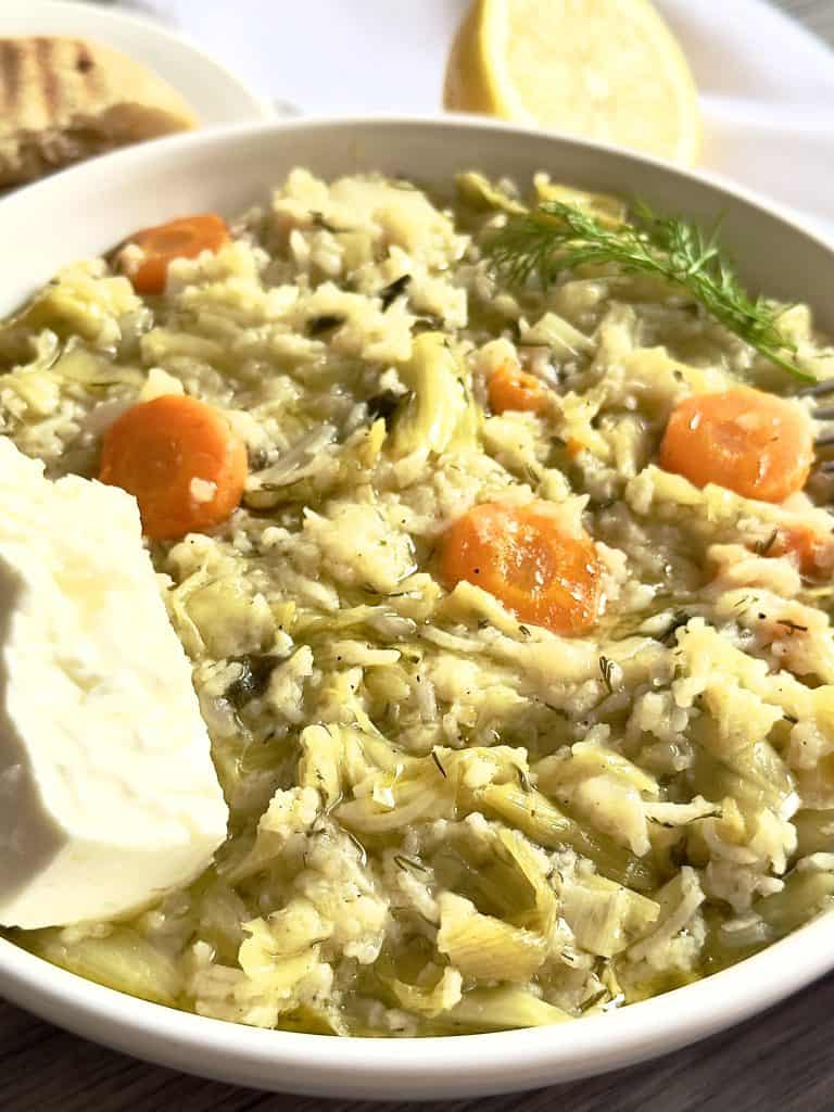 Greek Leek Rice on a dish with feta and pita