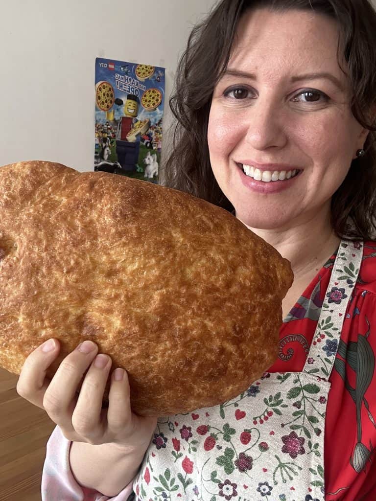 LADY HOLDING A LOAF OF BREAD