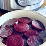 Cooked, sliced beets next to an Instant Pot
